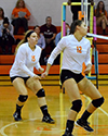 Seniors Sara Baum and Gina Duff in defensive position waiting for the ball to come over the net.