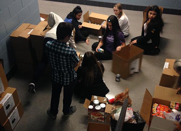 In the stairwell near the main office, Key Club members sorted and boxed food items that were donated during their annual drive.