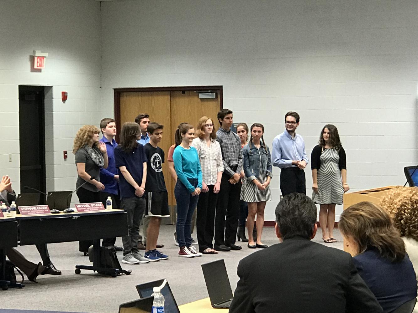 Students who took the National Merit Scholarship last year are presented with their award.