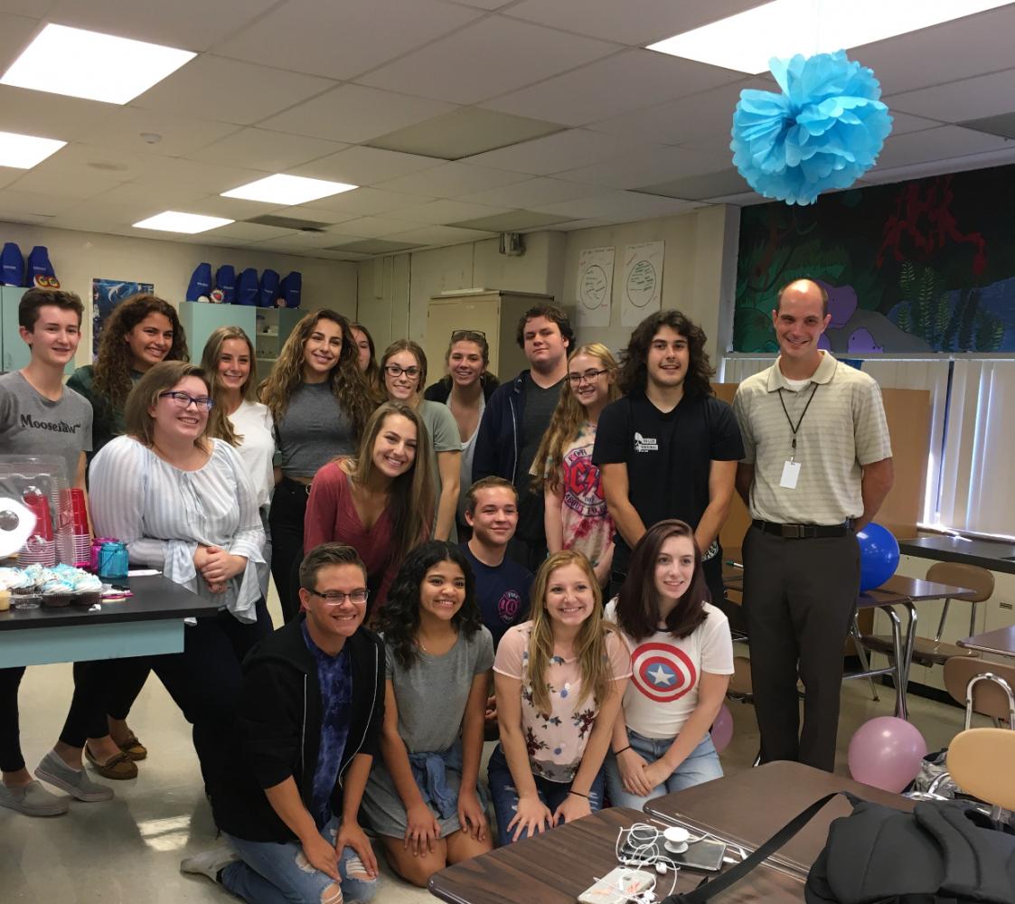 Teacher Bryant Sebastians sixth hour poses after surprising Sebastian with a baby shower.