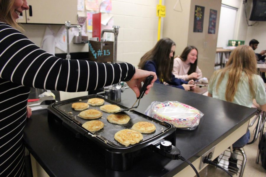 Teacher Courtney Struck makes pancakes for her first hour class celebrating mole day.
