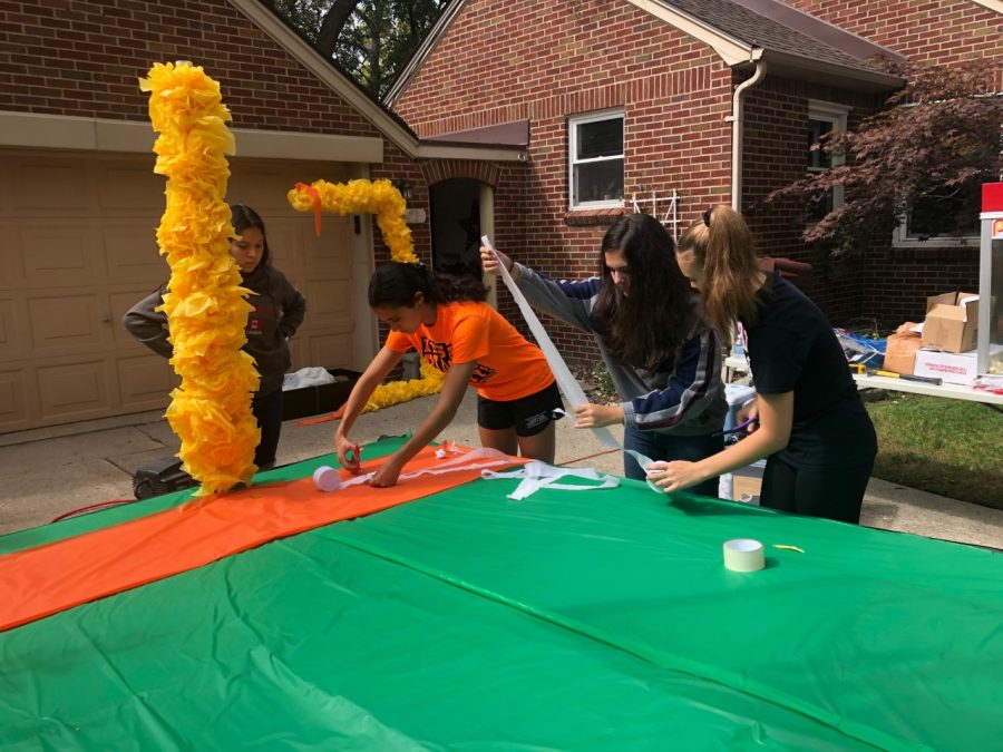 Sophomores add details to their homecoming float, a haunted football field.
