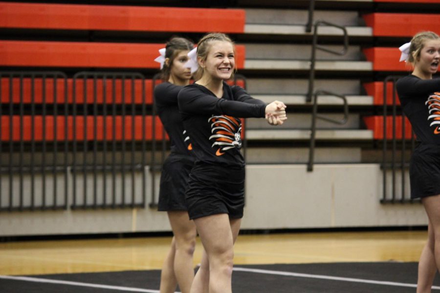 Junior+Jenna+Kilburg+practices+her+cheer+routine+before+the+varsity+team+performs.+