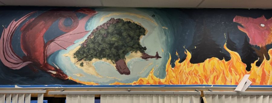 Seniors Zoie Garrett and Sadie Heman’s mural, featuring
references from multiple different stories such as the
dragon from “Beowulf” and the island from “Lord of the Flies,” is underway in room 235. The mural takes up al-
most the entire space above the window and is expect-
ed to be completed soon. Photo by Abby Williams