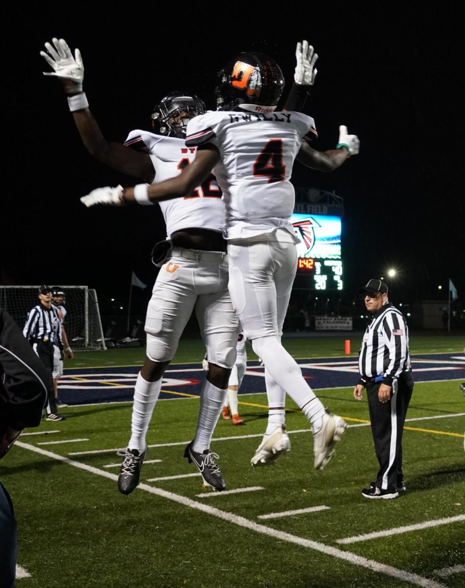 Brothers senior Numennhe Gwilly and sophomore Mahti Gwilly celebrate Mahtis touchdown against Henry Ford II.