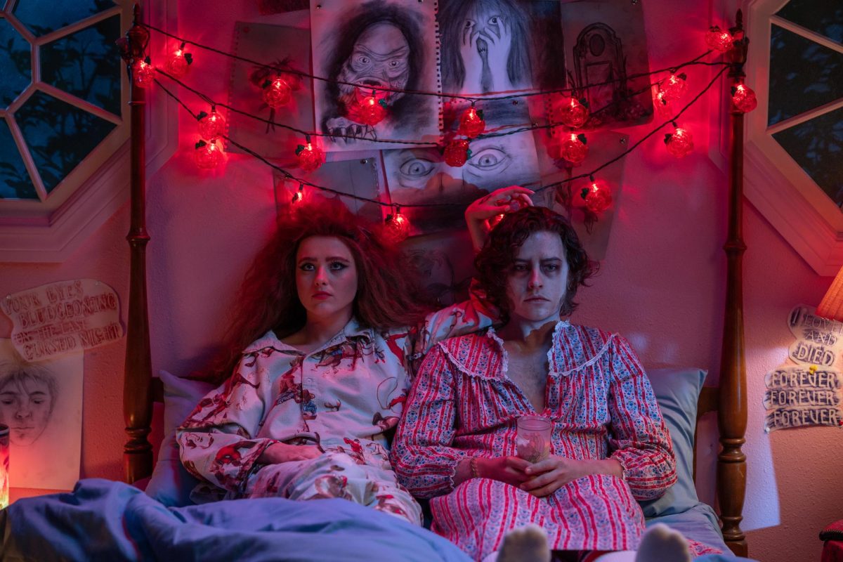 Kathryn Newton left sits left of Cole Sprouse as Lisa and “The Creature” in Lisa Frankenstein. 
