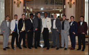 These gentlemen pose for a picture, showcasing their tuxes from Wesner Tuxedo.