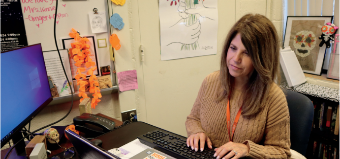 Teacher of the year Stacy Konnie works at her desk.