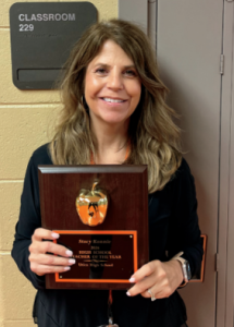 Teacher Stacy Konnie with her plaque she won for being teacher of the year.