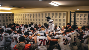 Junior Mahti Gwilly leads the team prayer before playoff game against Dakota. 