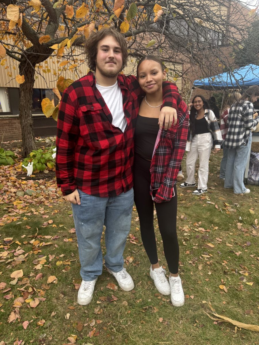 Seniors Michael Blum and Hannah Moyet at the Cider Mill hugging.