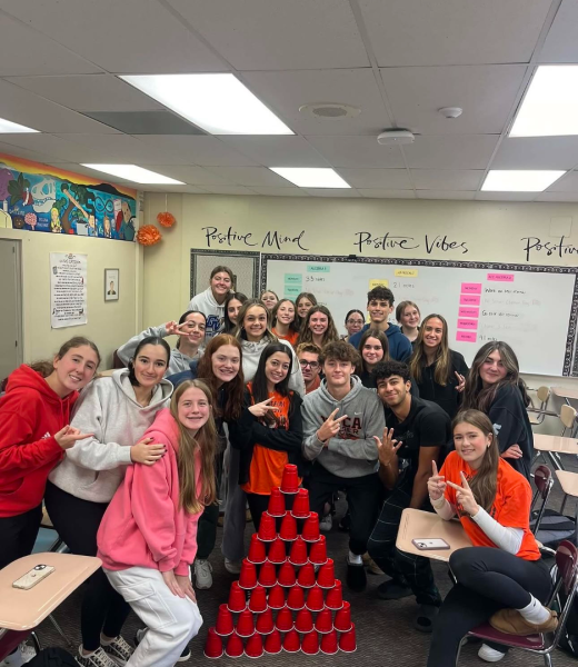 The Sophomore Senior Program meeting during lunch to stack cups.