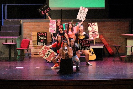 The ensemble, dressed as protestors, sing “We’re Not Gonna Take It” as they defend the Sunset Strip with junior Nikolina Anceski in the lead.