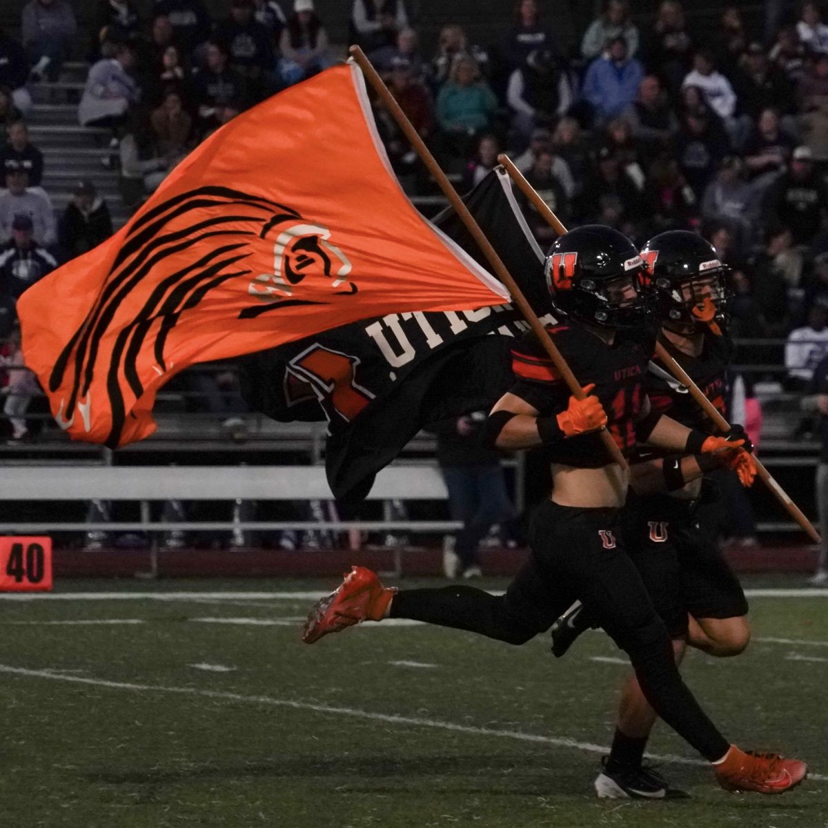 Photo of the Day #31!
At Friday night's varsity football game against Dakota, the varsity football team runs out with their Chieftain flags to kick off the game.