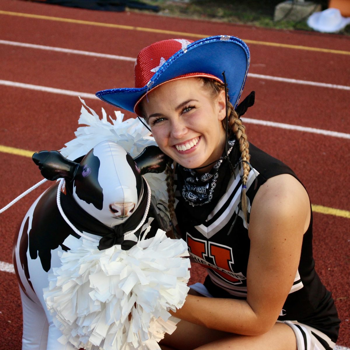 Photo of the Day #6!
Senior Kaylee Miller posing with the cow for the theme
"Cowboy," at the varsity football game last Friday night.