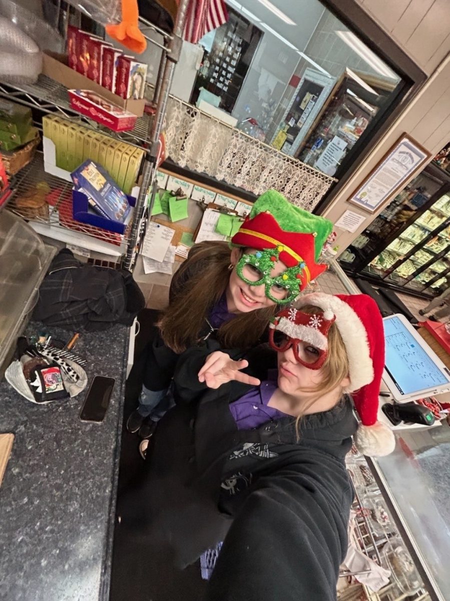 Junior Reese Nide with coworker Sophia Sydlowski showcasing their holiday cheer during work.