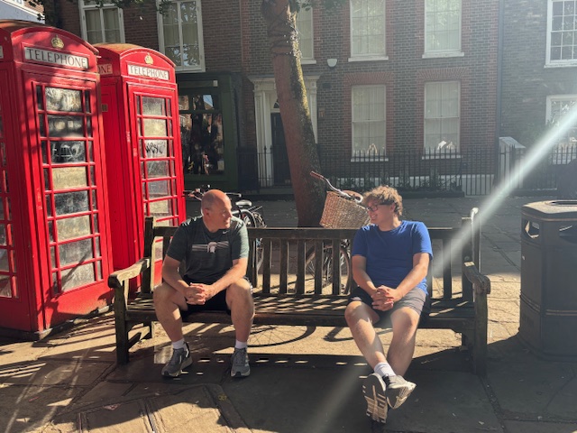 Scott Boice and senior Andrew Boice recreate a picture of coach Beard and Ted Lasso on a bench. 