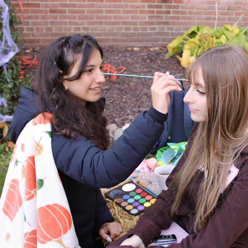 Photo of the Day #47!
On Oct. 31, senior Delana Dickow brings the spirit of the spooky holiday to the Cider Mill by painting the faces of Utica students.
