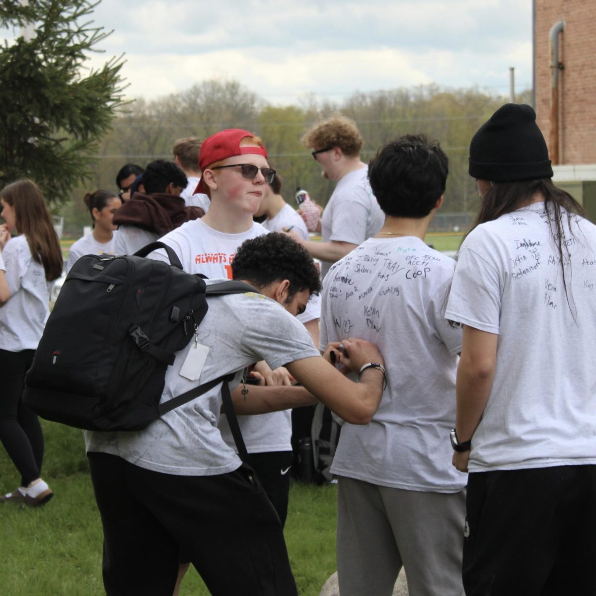 Photo of the Day #142!
As the seniors prepare for their final day surrounded by upcoming test and events, seniors took a couple moments out of their first day of May to slow down and leave a physical mark behind, accompanied with the impact they have had on Utica High School for the past three years via the annual hand print day and the signing of the t-shirts.